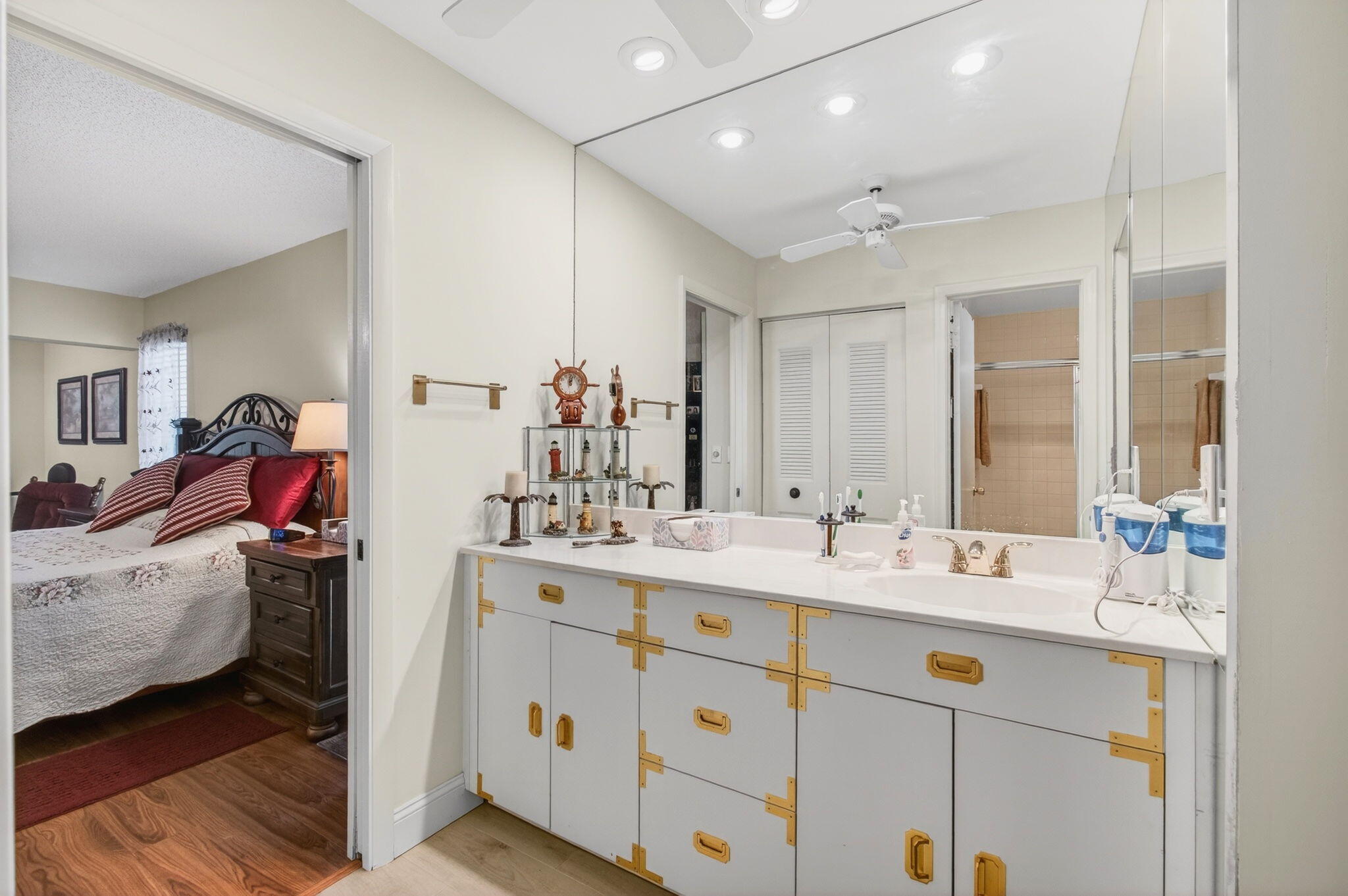 5452 Poppy Place, Unit D Delray Beach, FL 33484 - Photo 34 of 62 a bathroom with a double vanity sink and mirror