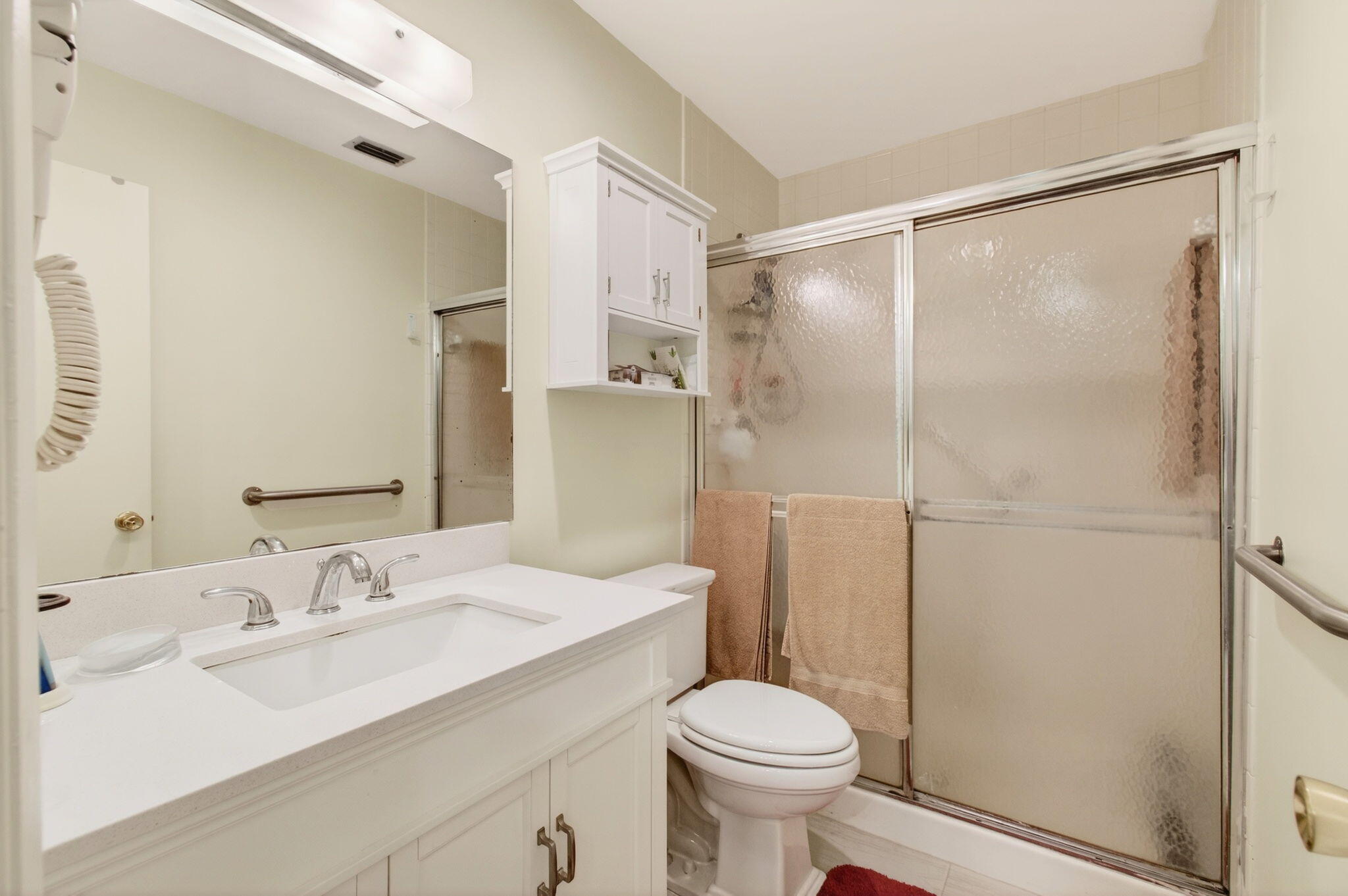 5452 Poppy Place, Unit D Delray Beach, FL 33484 - Photo 36 of 62 a bathroom with a sink toilet and shower