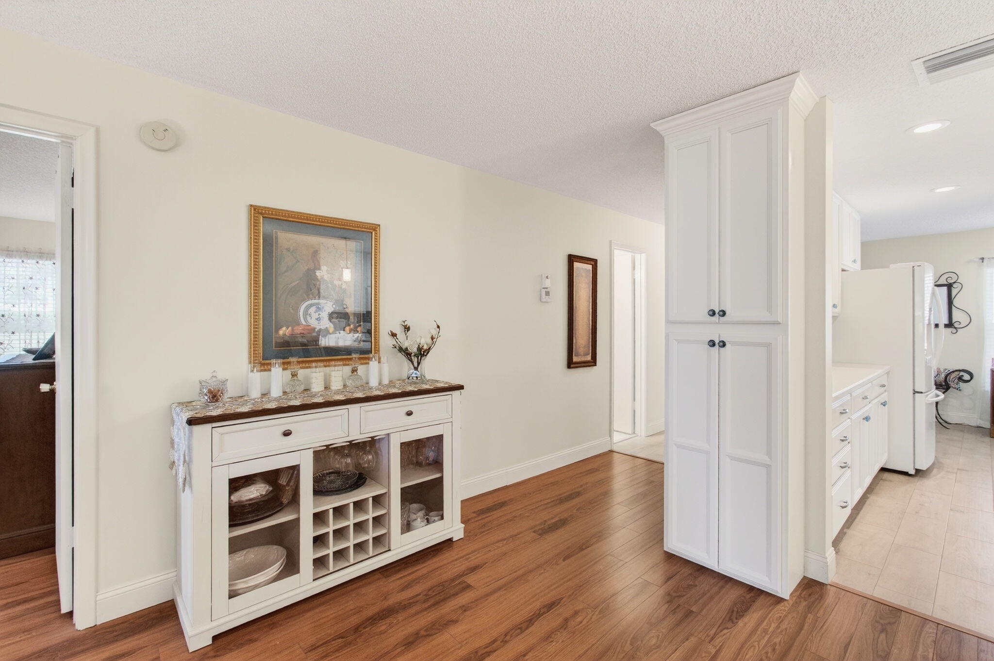 5452 Poppy Place, Unit D Delray Beach, FL 33484 - Photo 4 of 62 a view of a hallway with wooden floor and cabinet