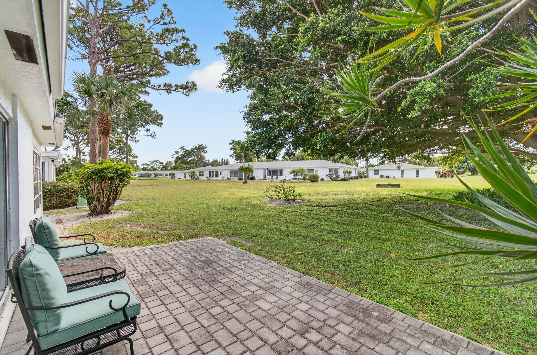 5452 Poppy Place, Unit D Delray Beach, FL 33484 - Photo 45 of 62 Private backyard patio with greenspace v
