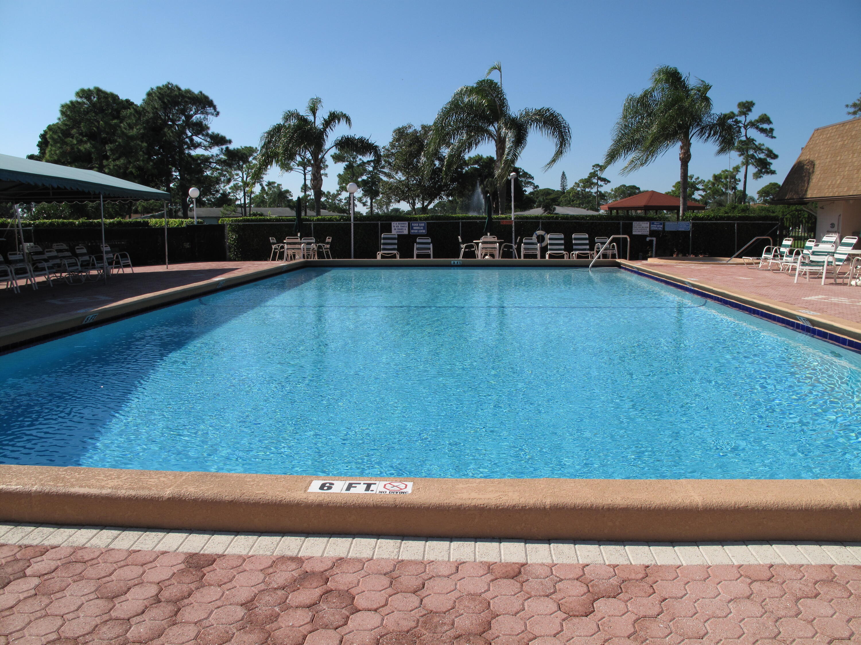 5452 Poppy Place, Unit D Delray Beach, FL 33484 - Photo 55 of 62 a view of swimming pool with outdoor seating and plants