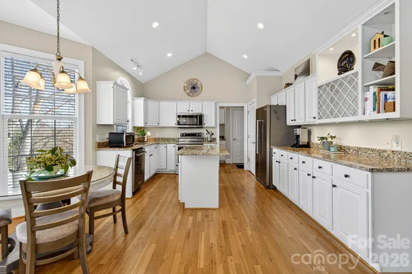 a kitchen with a stove a sink and a microwave