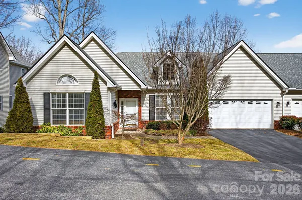 a front view of a house with a yard outdoor seating and garage