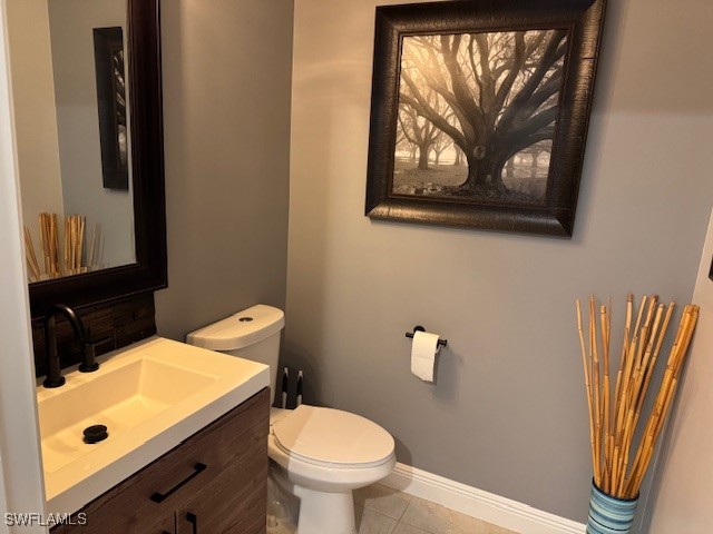 2743 First Street, Unit 105 Fort Myers, FL 33916 - Photo 6 of 29 a bathroom with a toilet a sink and mirror