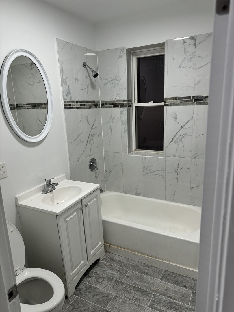1250 North Monitor Avenue Chicago, IL 60651 - Photo 15 of 28 a bathroom with a sink toilet and shower