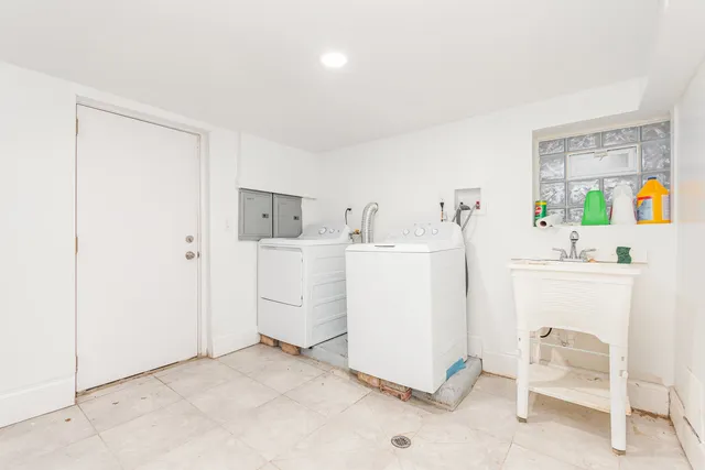 a utility room with cabinets washer and dryer