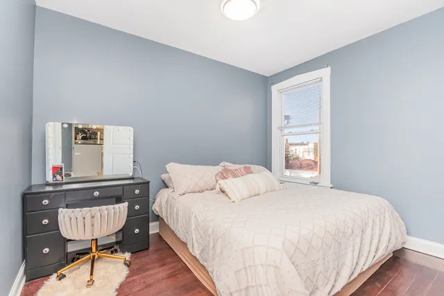 a bedroom with a bed window and a table