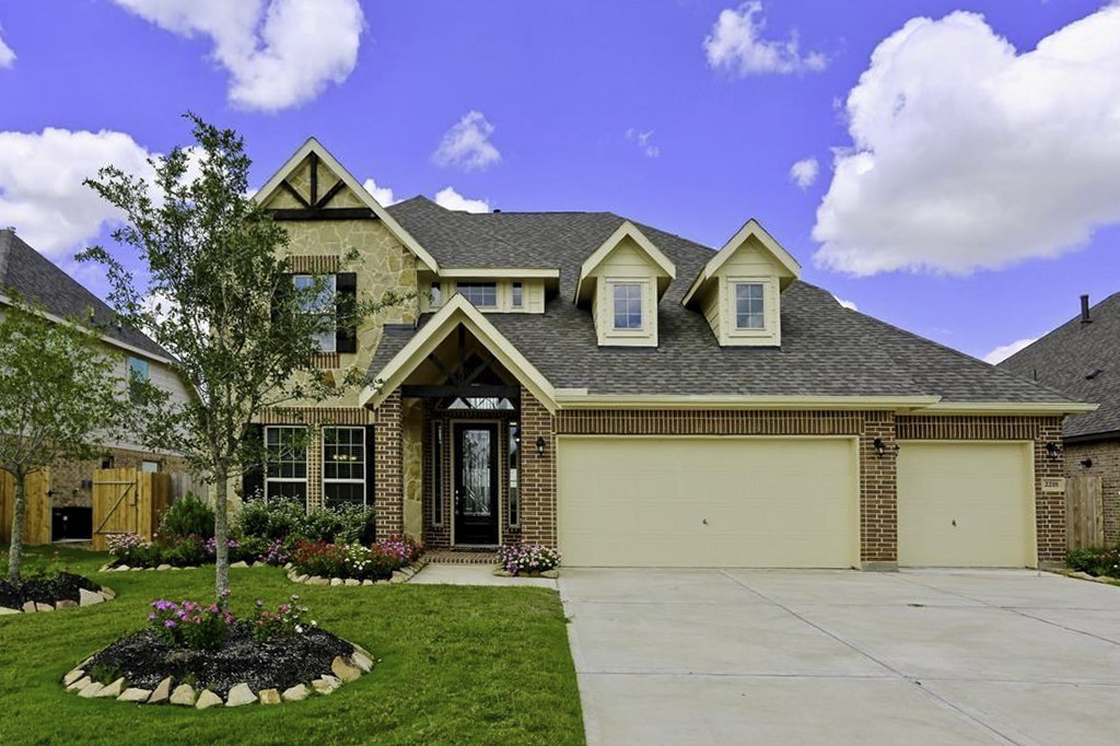 a front view of a house with a yard and garage
