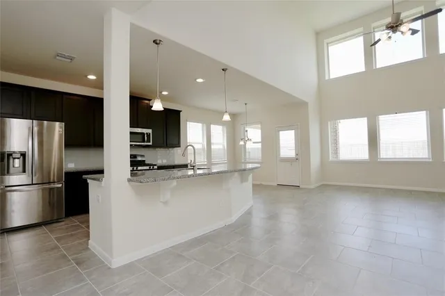 a view of a kitchen with a refrigerator and a sink