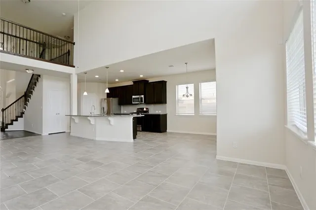 a view of a kitchen with kitchen island wooden floor and windows