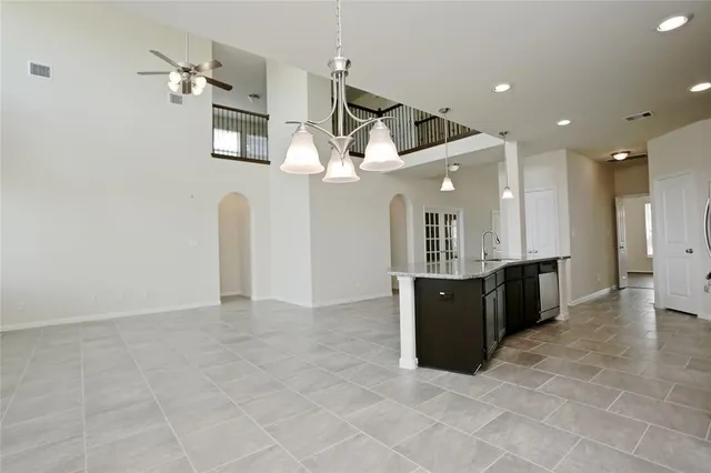 an open kitchen with a refrigerator and a sink