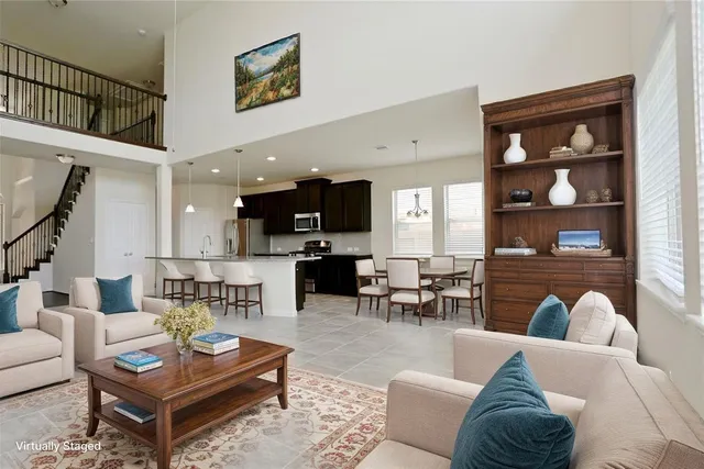 a living room with furniture and a painting on the wall