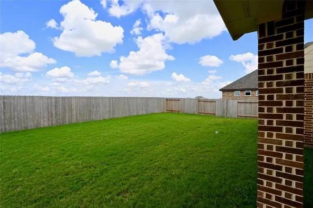 a view of a backyard with entertaining space