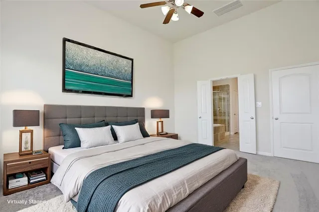 a bedroom with a bed and a painting on the wall