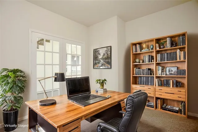a view of a workspace with furniture and a bookshelf