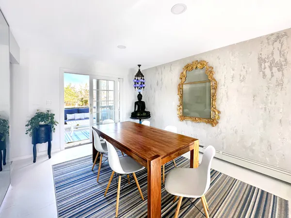 a dining room with furniture and wooden floor