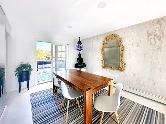 a dining room with furniture and wooden floor