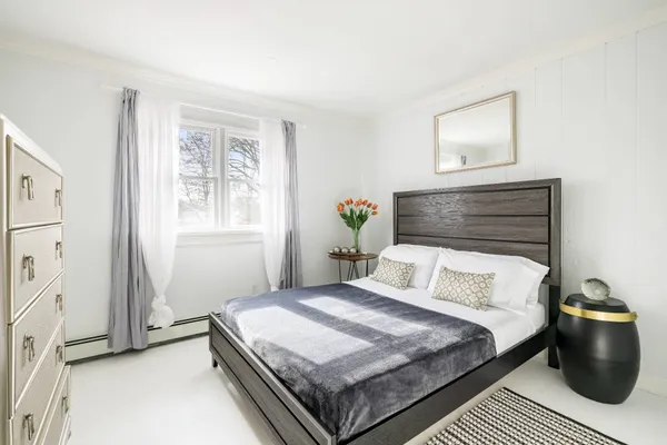 a bedroom with a bed and window