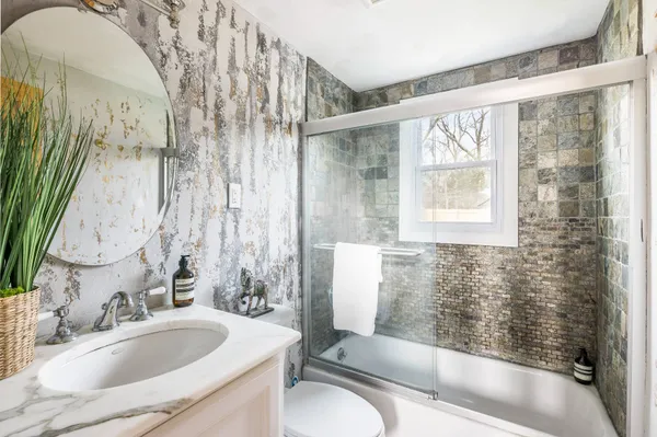 a bathroom with a sink and a large mirror