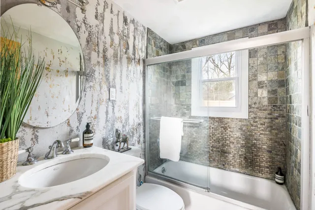 a bathroom with a sink and a large mirror