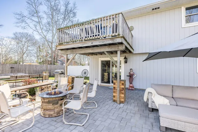a view of a patio with table and chairs potted plants with wooden floor