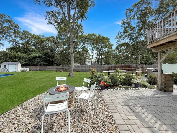 a view of a chair and table on the garden