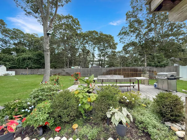 a view of a chair and table in the backyard