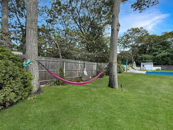 a view of swimming pool with a garden and trees