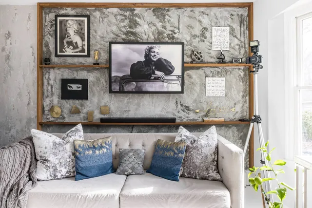 a living room with furniture and painting on the wall