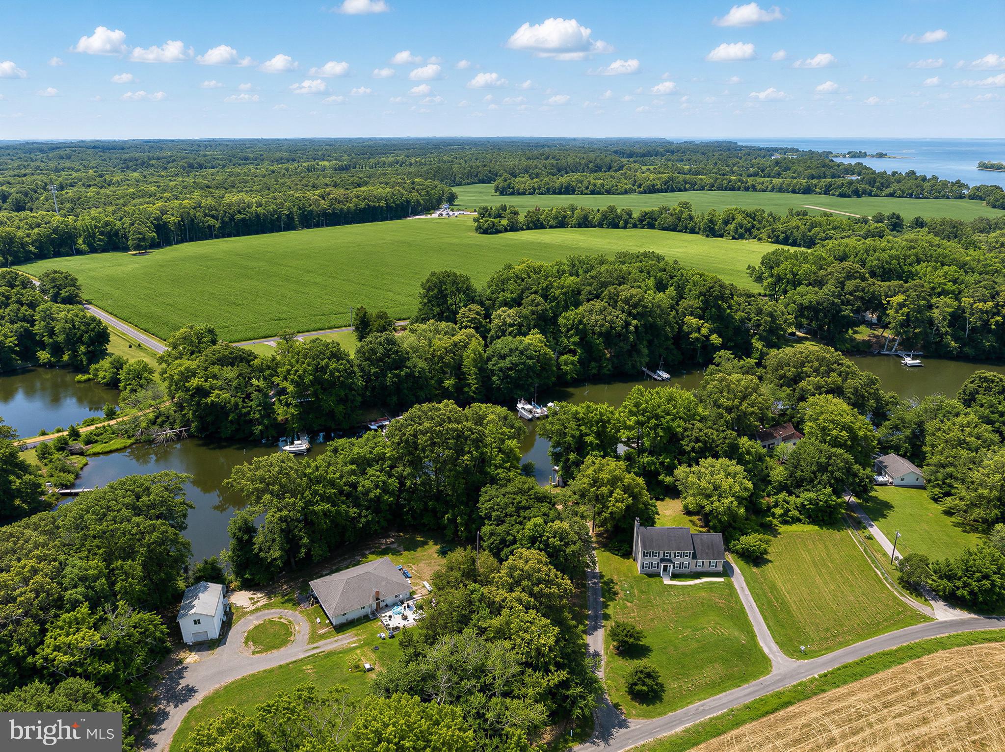 17248 Gum Landing Road St. Inigoes, MD 20684 - Photo 48 of 56 an aerial view of a house with a garden and swimming pool