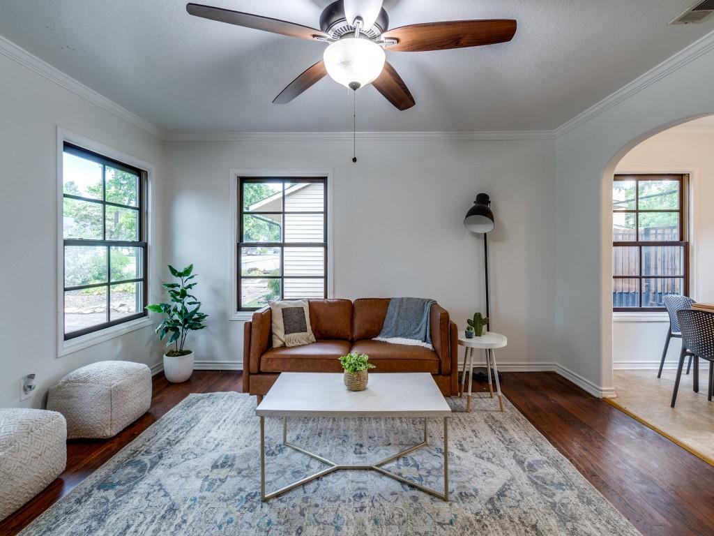 a living room with furniture and wooden floor