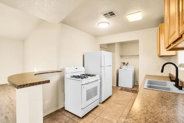 a kitchen with sink a stove and refrigerator