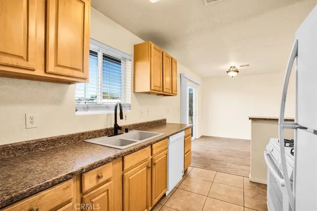 a kitchen with stainless steel appliances granite countertop a sink and a stove