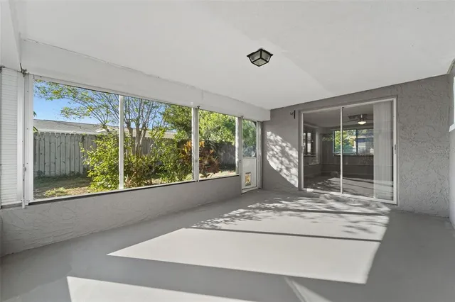 a view of a big room with large windows and a fireplace