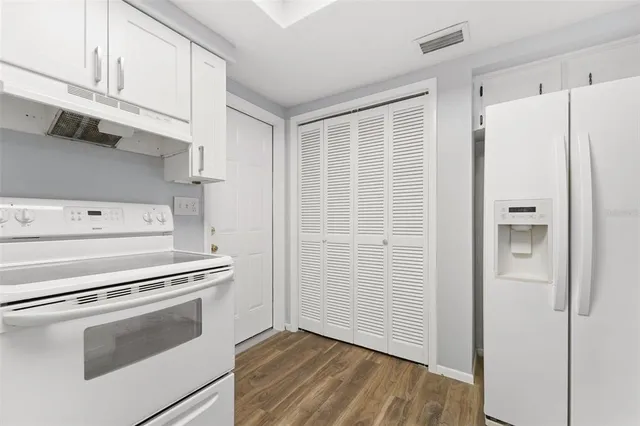 a stove top oven sitting inside of a kitchen