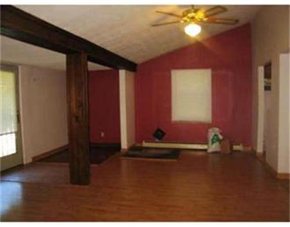 6 Walker Road Wales, MA 01081 - Photo 2 of 2 a room with gym equipment and a window