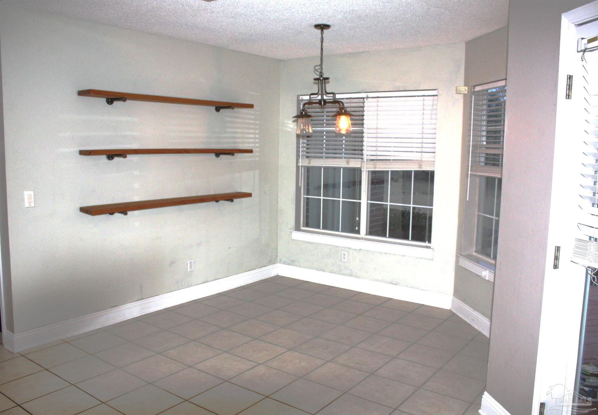 5708 Tamarack Drive Pace, FL 32571 - Photo 20 of 29 a view of an empty room with a window and cabinet