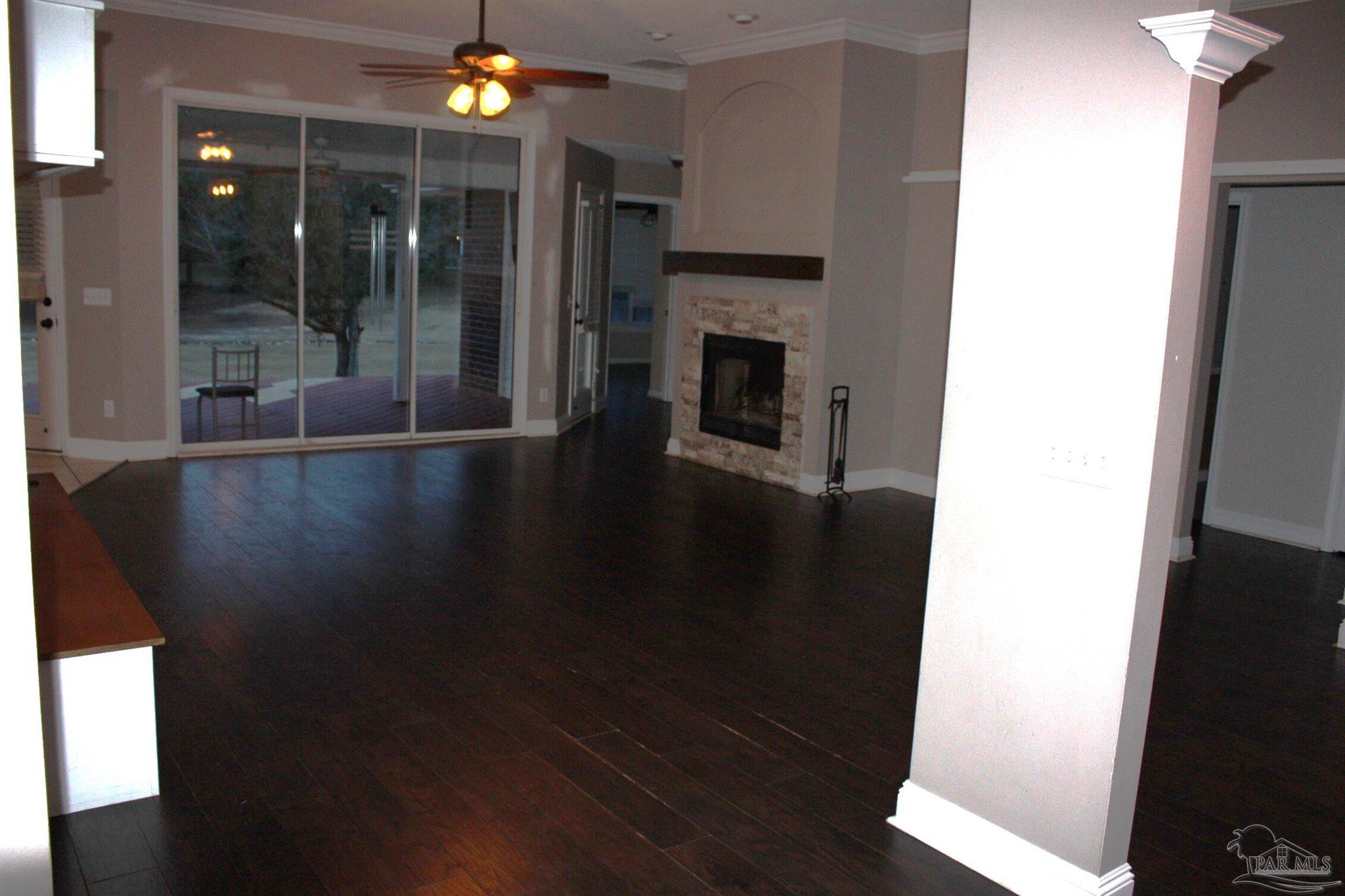 5708 Tamarack Drive Pace, FL 32571 - Photo 25 of 29 a view of an empty room with wooden floor and a window