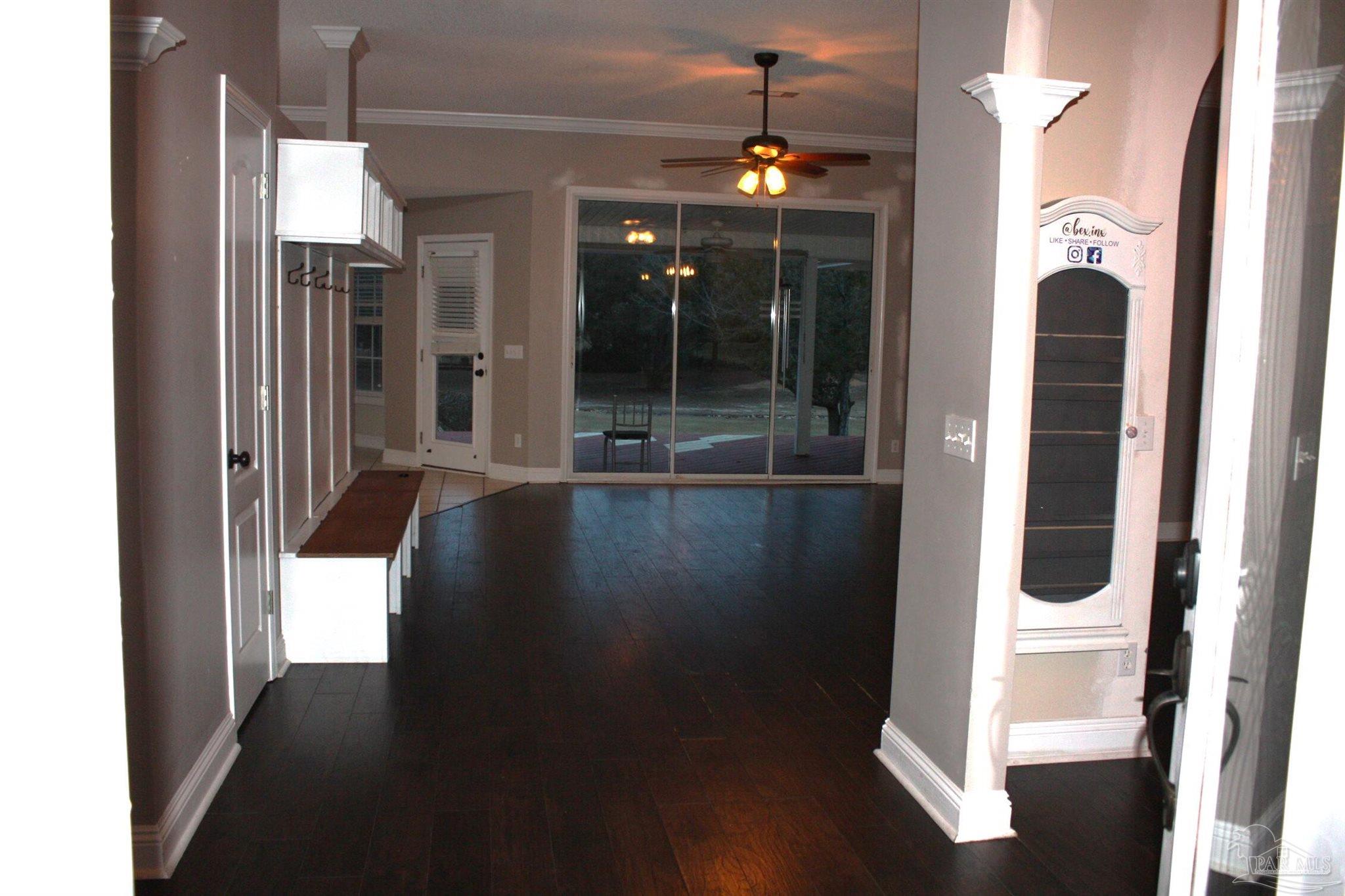 5708 Tamarack Drive Pace, FL 32571 - Photo 26 of 29 a view of a hallway with wooden floor and staircase