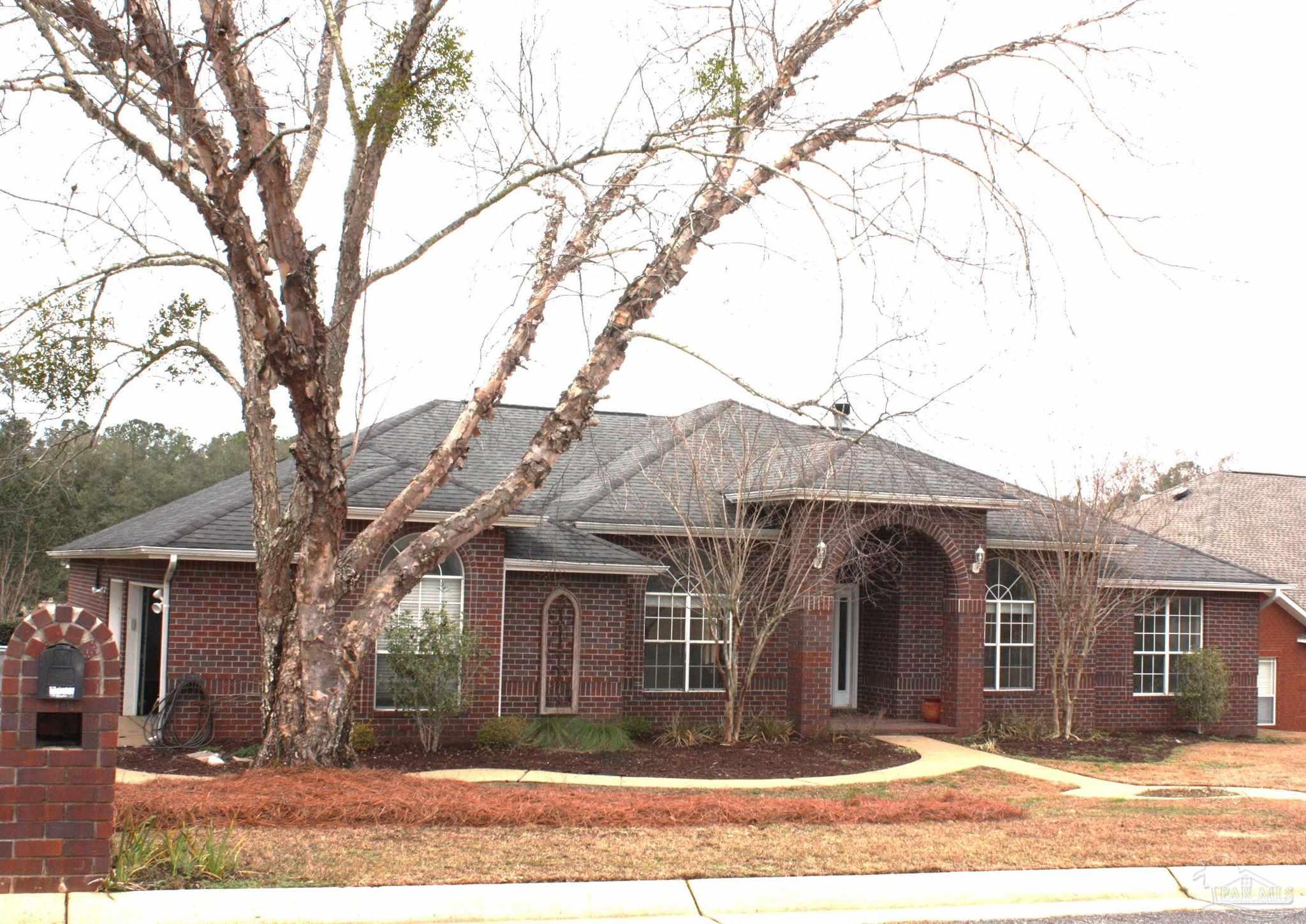5708 Tamarack Drive Pace, FL 32571 - Photo 29 of 29 a front view of a house with a tree and plants