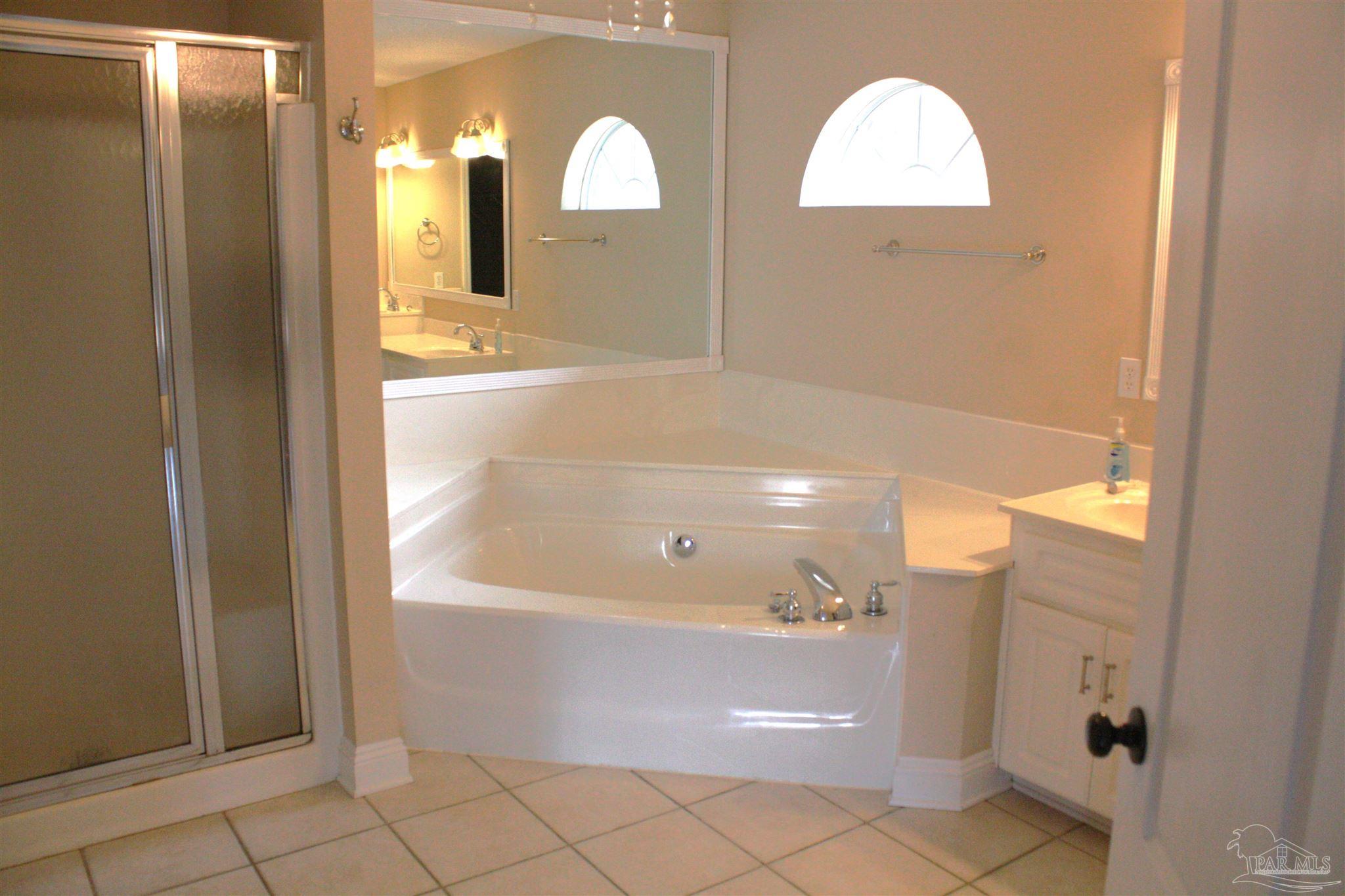 5708 Tamarack Drive Pace, FL 32571 - Photo 8 of 29 a bathroom with a bathtub and a shower