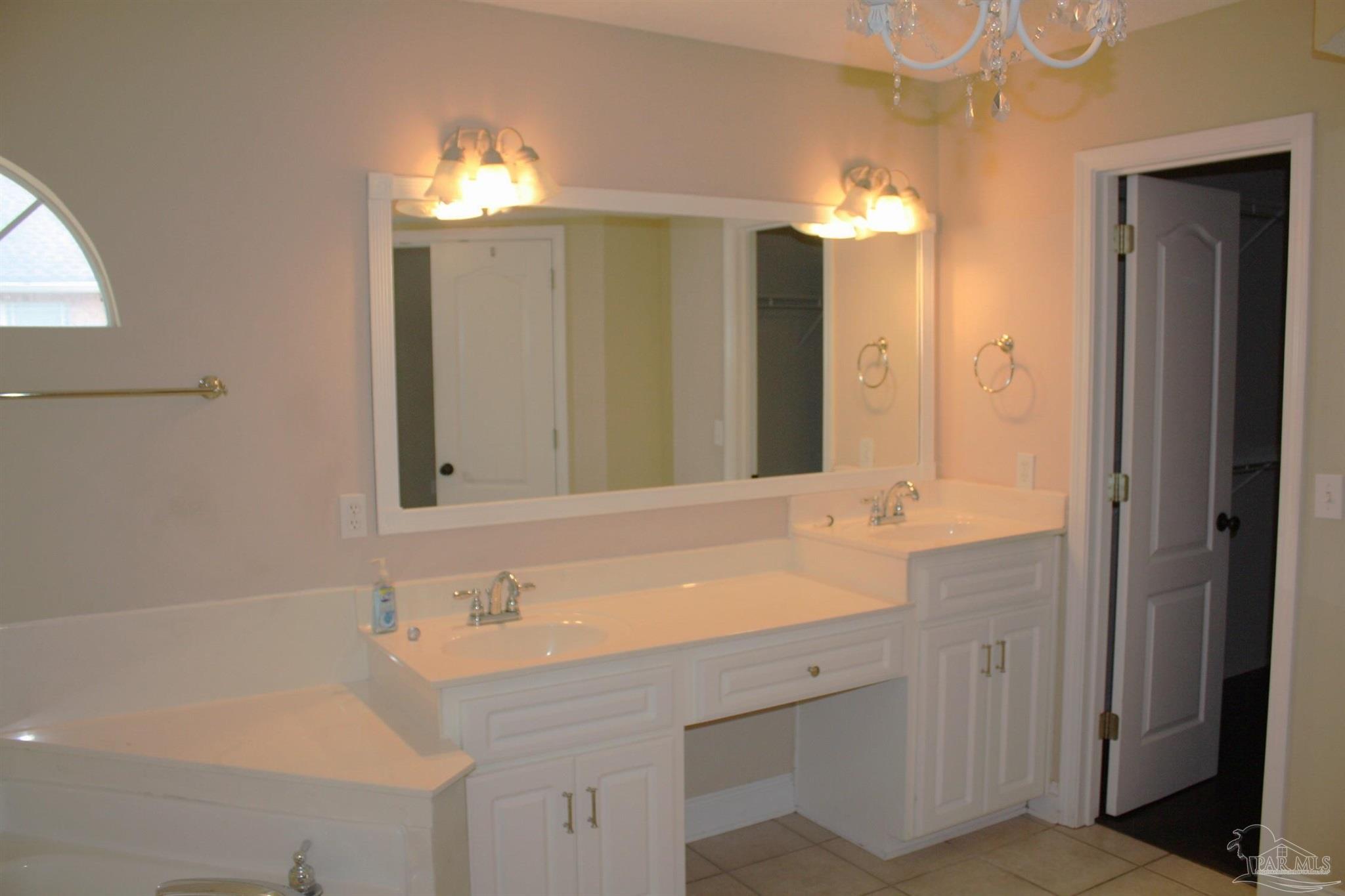 5708 Tamarack Drive Pace, FL 32571 - Photo 10 of 29 a bathroom with a sink double vanity and a mirror