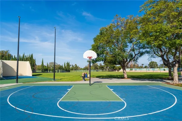 a view of a playground with basketball court