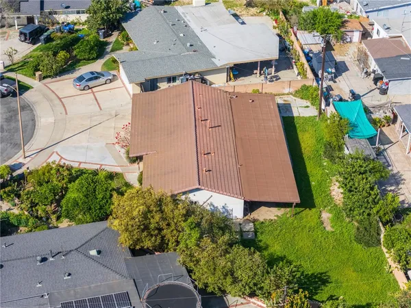 an aerial view of a house with garden space and street view