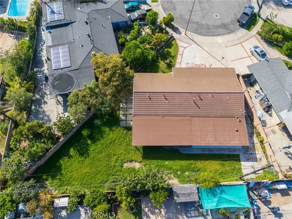 an aerial view of a house with a yard