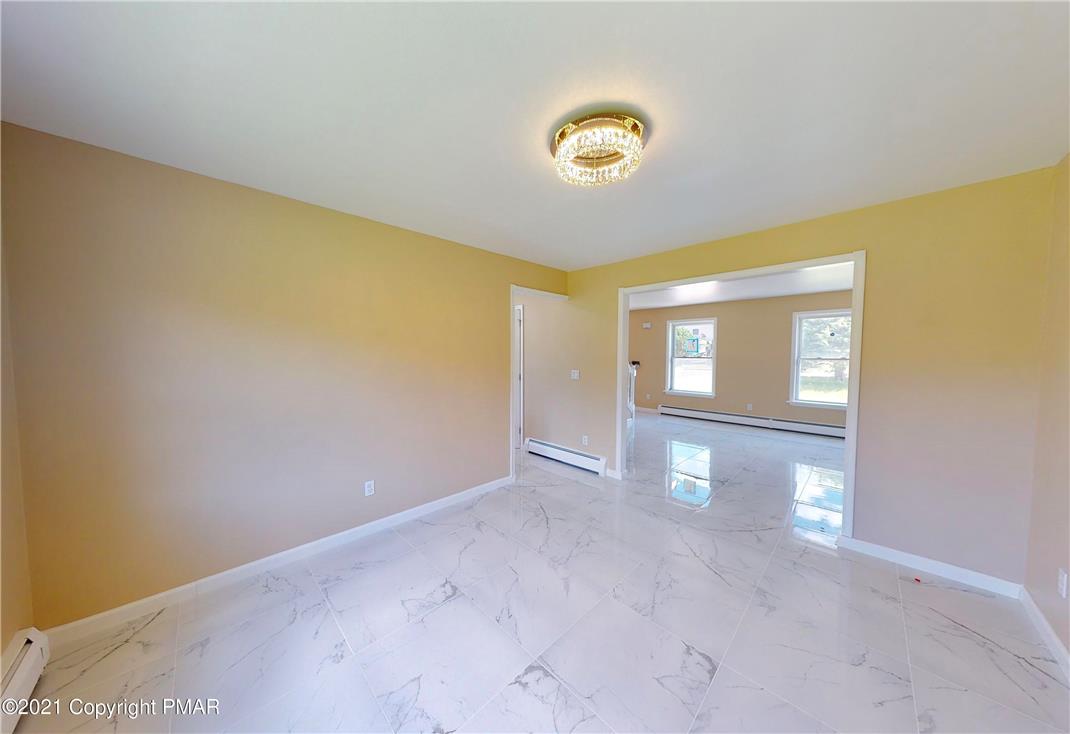 1110 Misty Ridge East Stroudsburg, PA 18302 - Photo 43 of 43 A chic chandelier illuminates the versatile, newly tiled living space with an open floorplan.