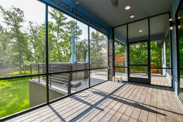 a view of a porch with wooden floor and outdoor seating