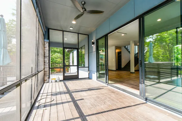 a view of a room with wooden floor and windows