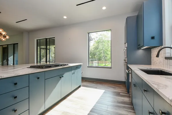 a kitchen with granite countertop a sink and a stove