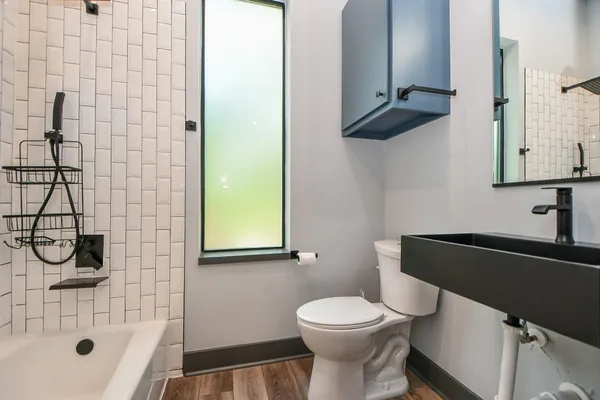 a bathroom with a toilet and a shower